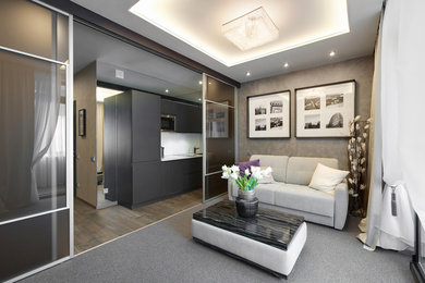 Photo of a small contemporary open plan living room in Moscow with beige walls, carpet, no fireplace and grey floors.