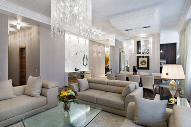 This is an example of a large contemporary formal open plan living room in Saint Petersburg with beige walls, medium hardwood flooring and a wall mounted tv.