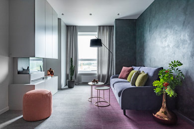 На фото: парадная, открытая гостиная комната среднего размера в современном стиле с разноцветными стенами, ковровым покрытием, стандартным камином, фасадом камина из металла и разноцветным полом без телевизора