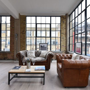 This is an example of a medium sized urban formal open plan living room in London with brown walls, medium hardwood flooring and beige floors.