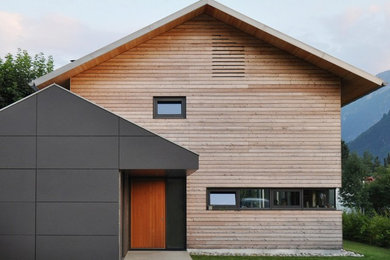 Zweistöckige, Mittelgroße Nordische Holzfassade Haus mit Satteldach und brauner Fassadenfarbe in München