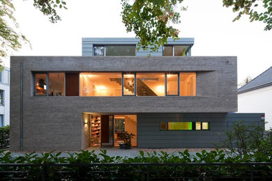 Modern house exterior in Berlin with three floors and a flat roof.