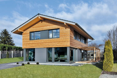 Zweistöckiges Modernes Einfamilienhaus mit Mix-Fassade, brauner Fassadenfarbe, Satteldach und Ziegeldach in München