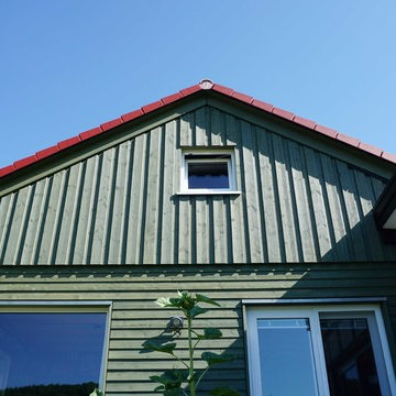 Haus Kaup - Individuelle Wohnhaus mit grüner Holzfassade und Fachwerk