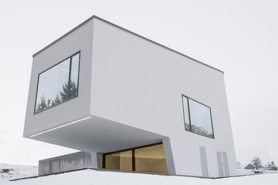 Inspiration for a large modern white three-story stucco exterior home remodel in Other