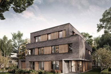 Imagen de fachada de casa gris actual grande a niveles con revestimiento de ladrillo, tejado plano y techo verde