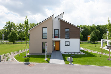 This is an example of an expansive and brown contemporary two floor detached house in Other with a lean-to roof, a tiled roof and wood cladding.