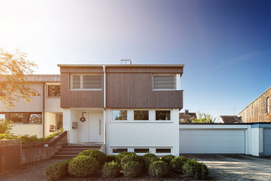 Modern mixed siding gable roof idea in Other with a tile roof