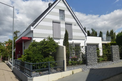 Foto de fachada gris contemporánea con revestimientos combinados y tejado a dos aguas