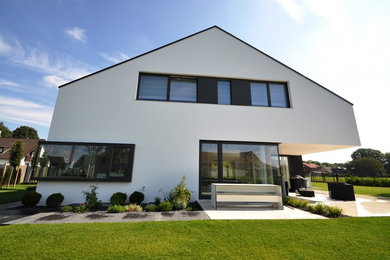 Foto de fachada de casa blanca actual extra grande con revestimiento de estuco, tejado a dos aguas y tejado de teja de barro