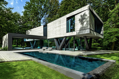 Zweistöckiges Modernes Einfamilienhaus mit grauer Fassadenfarbe und Flachdach in Hamburg