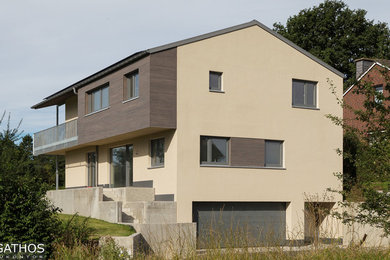Contemporary two floor house exterior in Cologne with mixed cladding.