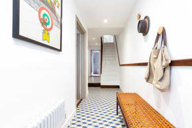 Foto di un ingresso o corridoio minimalista di medie dimensioni con pareti bianche, pavimento con piastrelle in ceramica, pavimento multicolore e soffitto ribassato