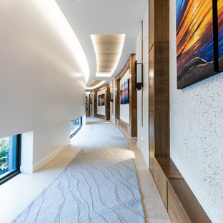 This is an example of a contemporary hallway in Sunshine Coast with white walls and beige floor.