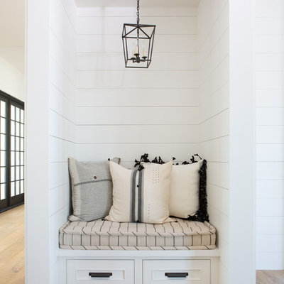 Hallway - mid-sized cottage light wood floor and brown floor hallway idea in Phoenix with white walls