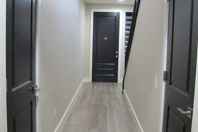 Inspiration for a timeless light wood floor hallway remodel in Las Vegas with gray walls