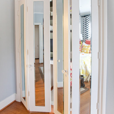 Inspiration for a mid-sized contemporary medium tone wood floor and brown floor hallway remodel in Dallas with blue walls