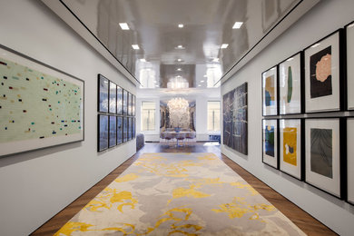 Hallway - contemporary medium tone wood floor hallway idea in New York with white walls