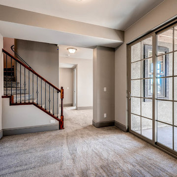 Basement hallway featuring glass doors