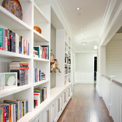 Trendy dark wood floor hallway photo in Los Angeles with white walls