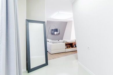 Mid-sized minimalist concrete floor hallway photo in Other with white walls
