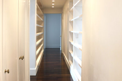 Hallway - large contemporary dark wood floor hallway idea in New York with white walls