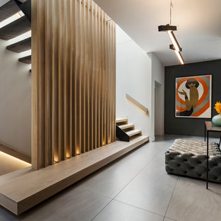 This is an example of a contemporary hallway in Melbourne with black walls and grey floor.