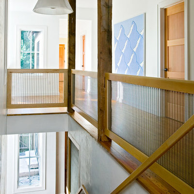Mid-sized country medium tone wood floor and brown floor hallway photo in Bridgeport with white walls