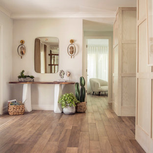 Mid-sized danish porcelain tile and brown floor hallway photo in Miami with white walls