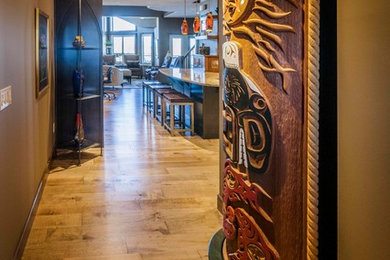 Example of a mid-sized transitional medium tone wood floor hallway design in Calgary with brown walls