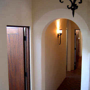 Custom Arch way and Herringbone clay flooring in small Spanish Bungalow