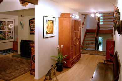 Inspiration for a mid-sized light wood floor and beige floor hallway remodel in DC Metro with yellow walls