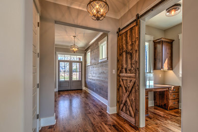 Inspiration for a mid-sized transitional medium tone wood floor hallway remodel in Jacksonville with gray walls