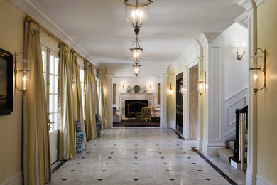 Example of a classic marble floor and multicolored floor hallway design in San Francisco with beige walls