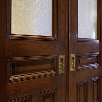 Custom White Oak Raised Panel Pocket Doors with Opaque Glass Panels