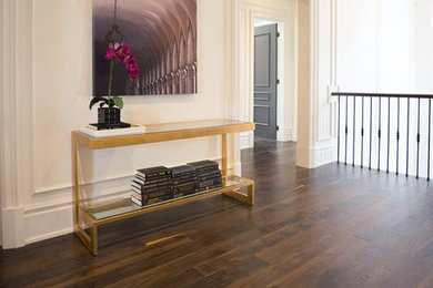 Example of a mid-sized transitional dark wood floor and brown floor hallway design in Vancouver with white walls