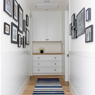 Photo of a transitional hallway in Los Angeles with white walls and medium hardwood floors.