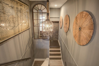 Large trendy light wood floor and brown floor hallway photo in Calgary with gray walls
