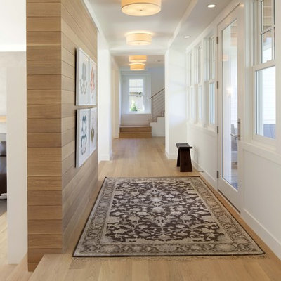 Trendy medium tone wood floor and beige floor hallway photo in Minneapolis with white walls