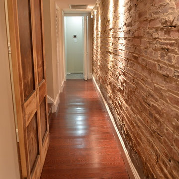Exposed brick wall and sliding barn door in hall