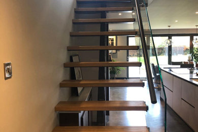 Design ideas for a medium sized modern staircase in Sussex.