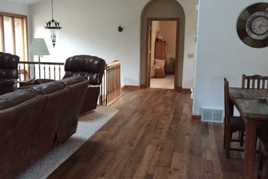 Large elegant medium tone wood floor and brown floor hallway photo in Minneapolis with white walls