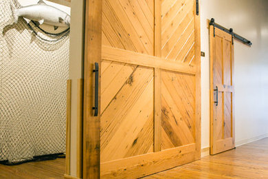 Example of a large urban light wood floor hallway design in Seattle with white walls