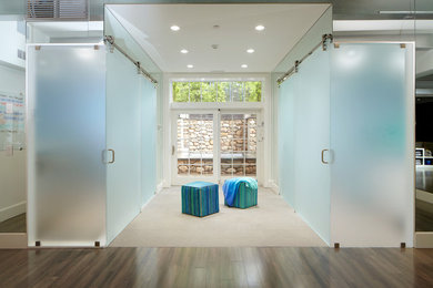 Inspiration for a large modern beige floor and dark wood floor hallway remodel in New York with beige walls