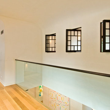 Glass interior wall and pivoting interior windows