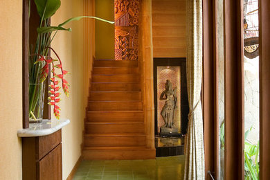 Inspiration for a tropical multicolored floor hallway remodel in Other with beige walls