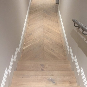 Hallway and steps Chevron engineered parquet flooring.