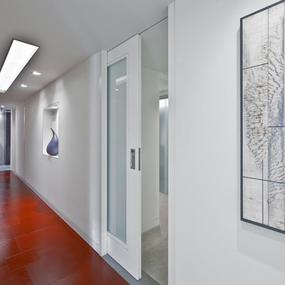 Example of a mid-sized trendy red floor hallway design in Seattle with white walls