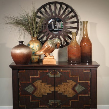Hallway Side Table with Southwestern Style Accents, Large Orange Vases and Wagon
