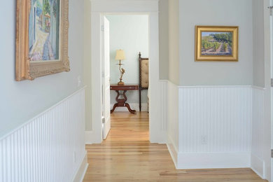Hallway - small traditional medium tone wood floor hallway idea in Charleston with gray walls